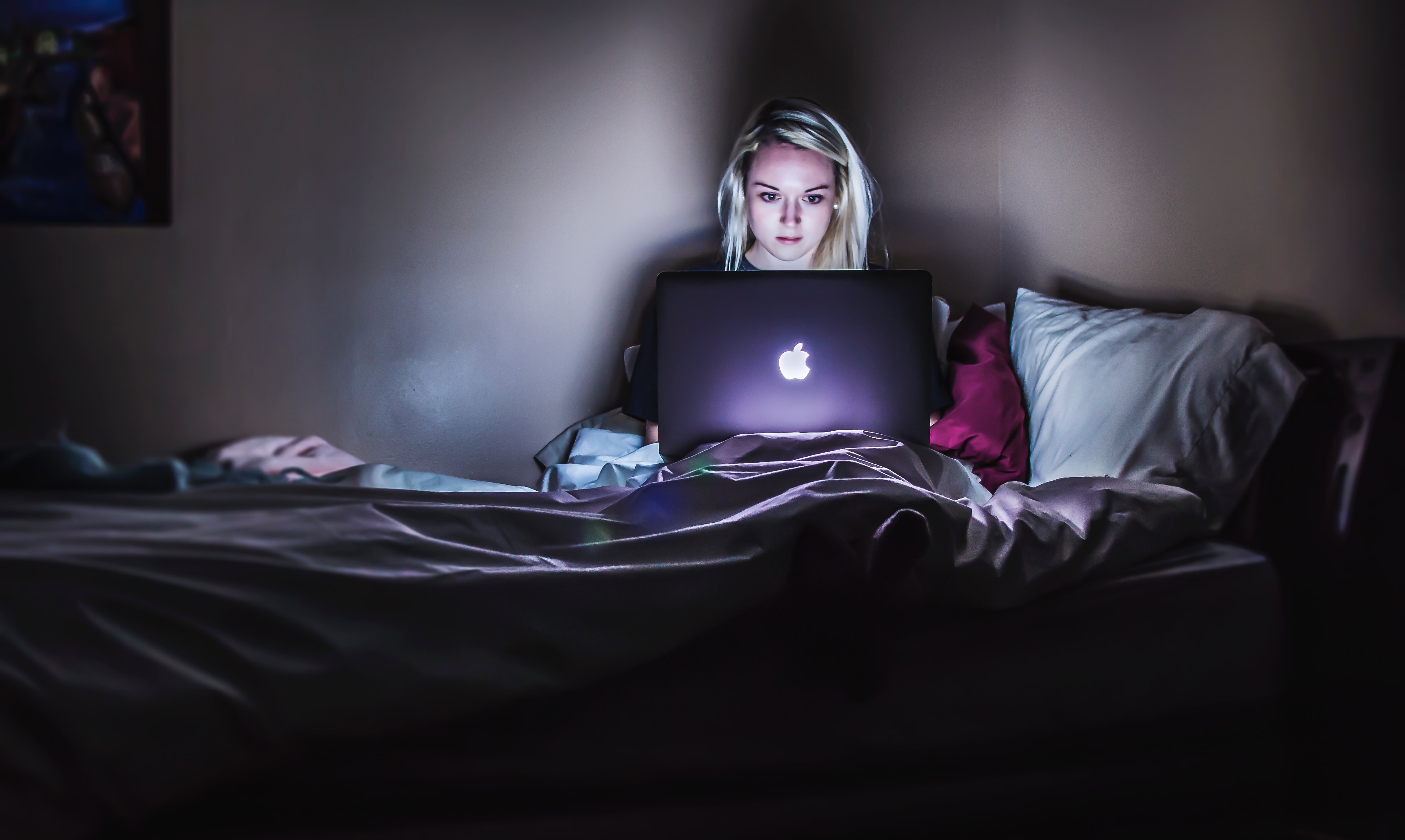 girl on laptop in the dark 