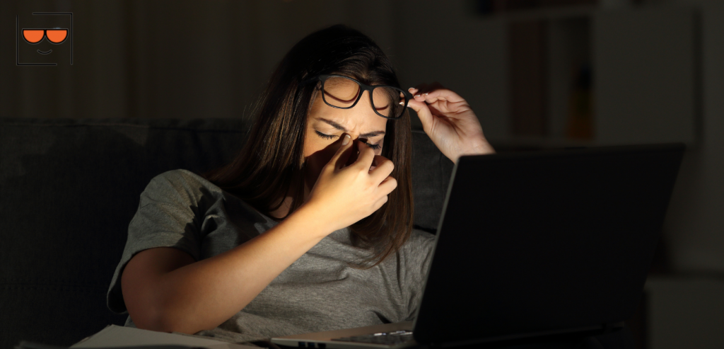 Women suffering from eyestrain from the blue light coming off her laptop